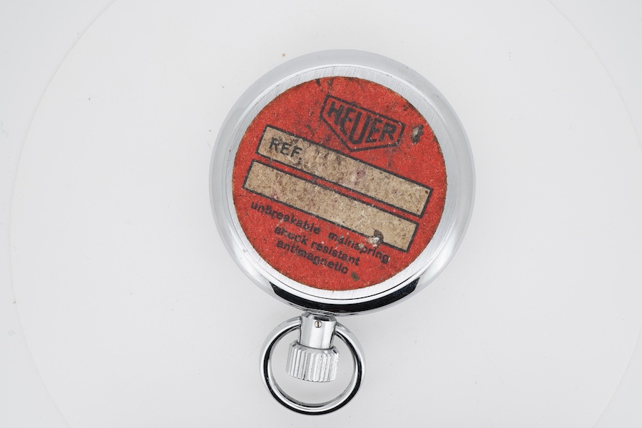 A chrome cased Tag Heuer stopwatch, the back with original red sticker, case diameter 50mm.